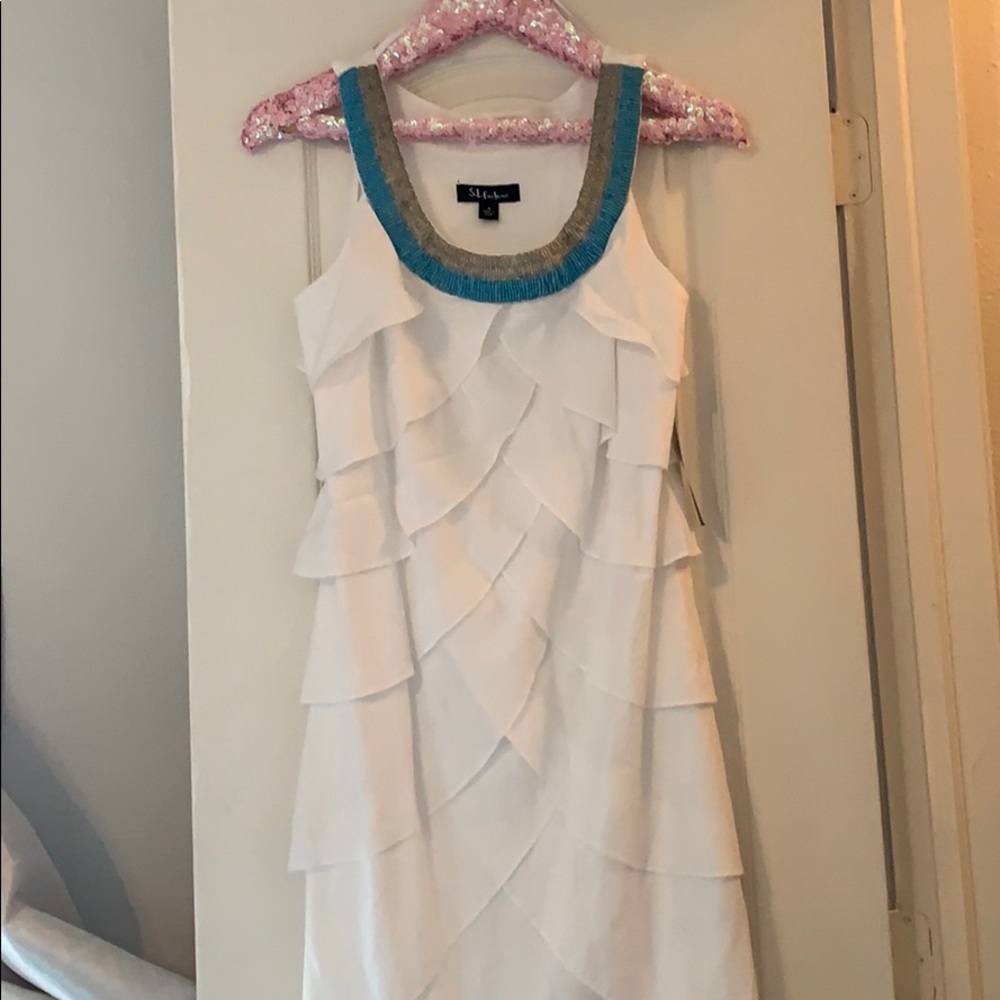 Beautiful tiered dress with beaded neckline.